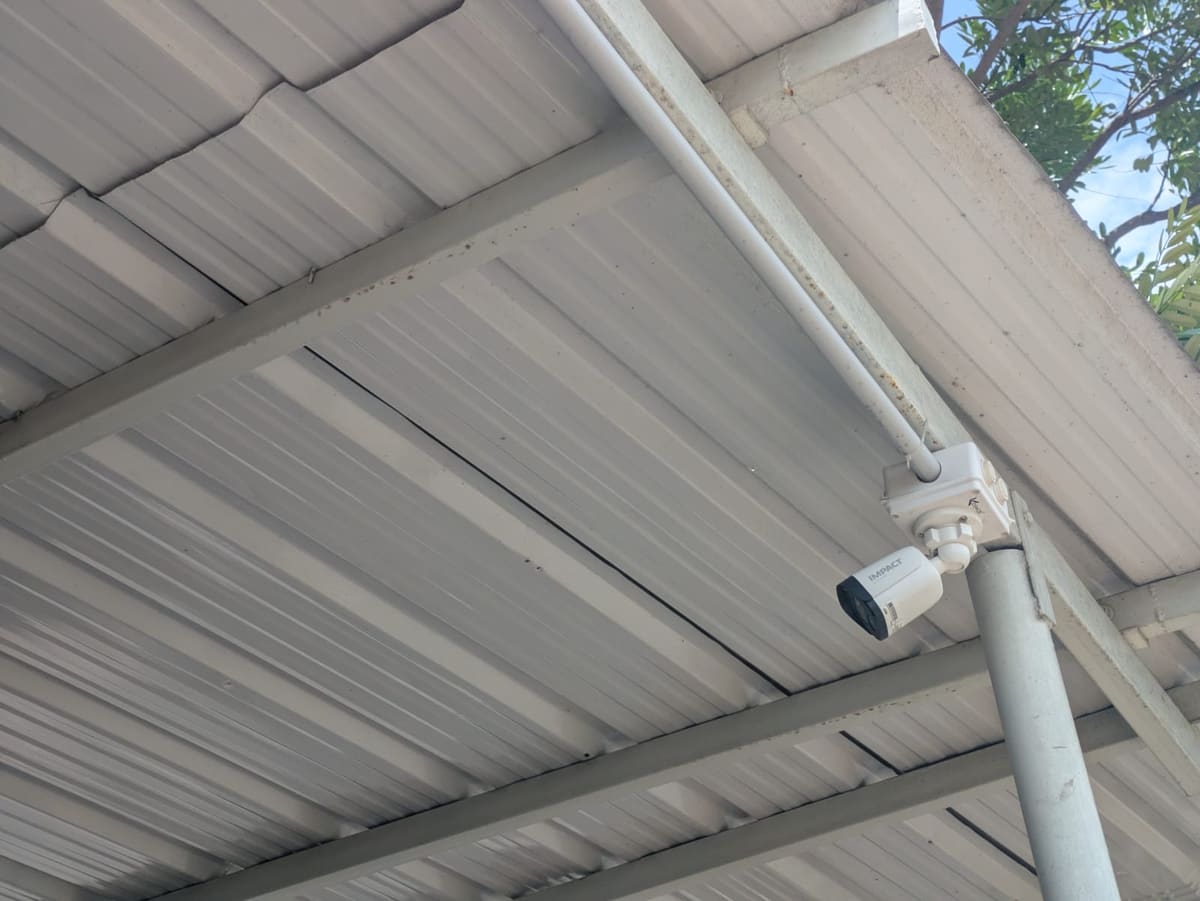 Outdoor CCTV camera installed under a commercial roof at a Tirupur unit